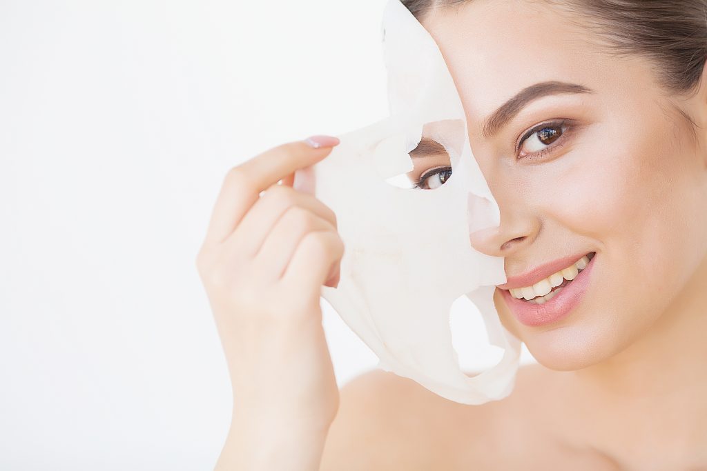 Skin Care. Beautiful Girl With Sheet Mask on Her Face